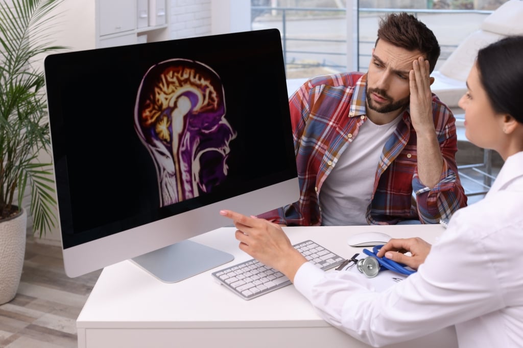 Medico spiega al paziente i tumori del sistema nervoso centrale